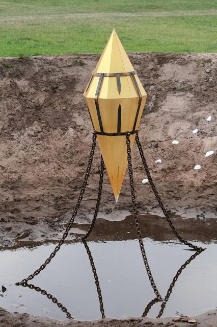 a yellow and black object sitting in the mud