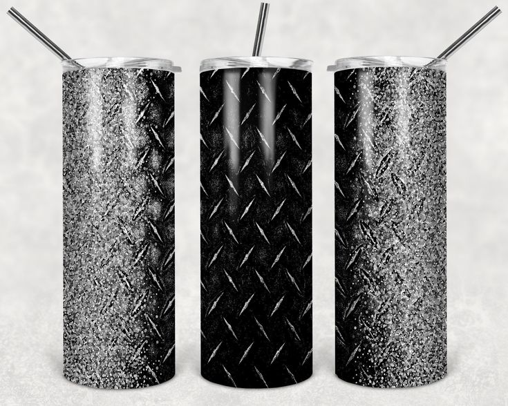 three black and white cans with straws in them