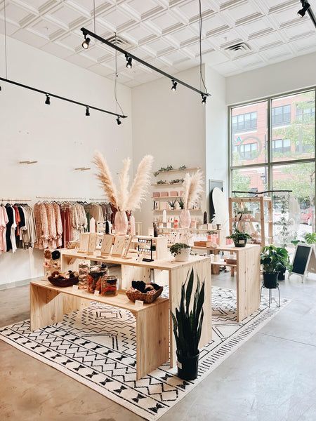 a clothing store filled with lots of clothes and plants