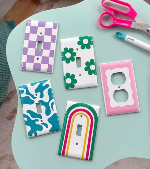 several different types of light switch covers on a table with scissors and other items around them