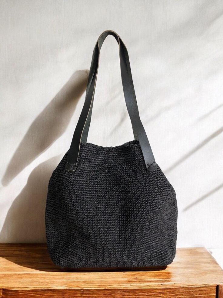 Any woman must have this bag for every fashionista. Whether you keeping it to yourself or gifting someone you care, it will be unforgettable. ✔️I made this beautiful bag from natural paper rope which is organic cotton and vegan leather in black. ✔️The interior of the straw summer bag is fully lined with cotton and has a magnetic button. Suitable for use as shoulder bag, beach bag, travel bag or party bag. ✔️The bag has cotton lining. A lining of the appropriate color is sewn into the crochet pap Vacation Handheld Shoulder Bag With Leather Handles, Handheld Shoulder Bag With Leather Handles For Vacation, Trendy Beach Hobo Bag With Leather Handles, Trendy Hobo Bag With Leather Handles For Beach, Trendy Hobo Bag With Leather Handles For Vacation, Trendy Black Handwoven Bag, Black Crochet Bag For Beach Season Travel, Black Large Capacity Straw Bag For Beach Season, Handheld Crochet Bag With Leather Handles For Travel