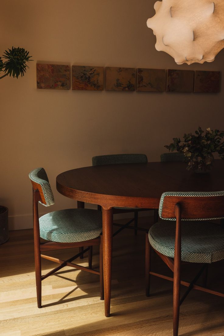 a wooden table with four chairs around it