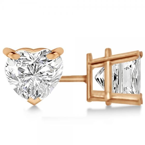 These bright four-prong basket moissanite earrings are built in 14kt rose gold. Featured in these captivating earrings are 2 excellent cut F-G VVS1 heart moissanites. Glossy moissanites set in a prong setting form these designer moissanite stud earrings. Available as screw backs or push backs, these single-stone moissanite earrings have a two carat total weight. Proudly made in USA, these studs are available in other metals, and carat weights. Free third-party appraisal included. #studearrings Heart Shaped Diamond Earrings, Diamond Solitaire Earrings, Gold Heart Earring, Rose Gold Earrings Studs, Heart Shaped Jewelry, Earrings Rose Gold, Rose Gold Studs, Earrings Heart, Heart Shaped Earrings