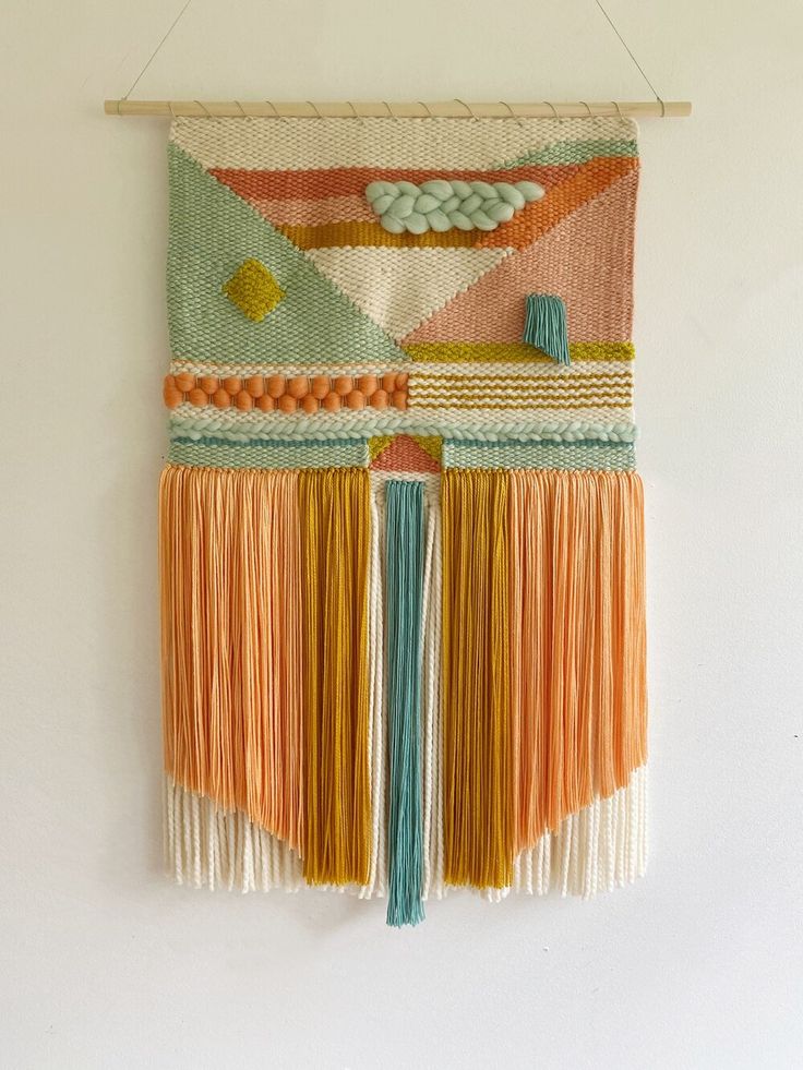 a wall hanging with fringes on it