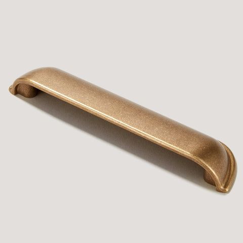 an antique brass door handle on a white background