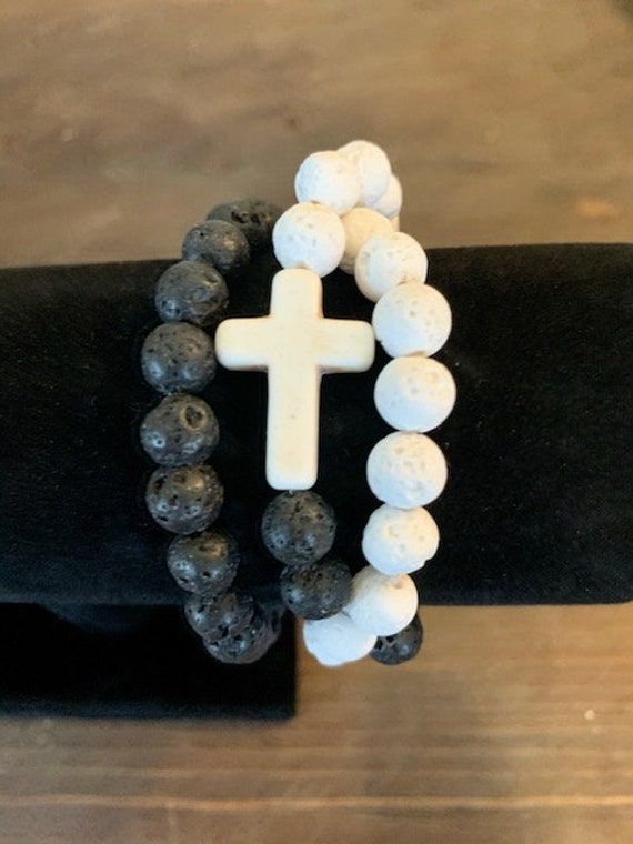 "NEW! Wrap around  Bracelet or wear as a Neckless! Offering His and Her Set, Sku LAHH -001  His comes in a 10mm Bead size with 2\" cross and Hers comes in a 8mm bead size with  1\" cross  New Wrap around, 10 mm Black Lava Rock, 1 mm Strong clear Stretch cord for easy wear, two inch White and Black Semi-Precious  Howlite cross. Offering His and Her Set, Sku LAHH -001  His comes in a 10mm Bead size with 2\" cross and Hers comes in a 8mm bead size with a 1\" cross  In Variation choose the Cross Col White Cross Bracelet Spiritual Style, Christian Jewelry Bracelets, Bible Verse Bracelet, Wrap Around Bracelet, Jesus Gifts, Christian Bracelets, Confirmation Gifts, Lava Rock, Lava Bead