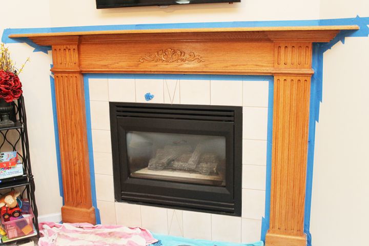 a fireplace with a tv above it and some toys on the floor next to it