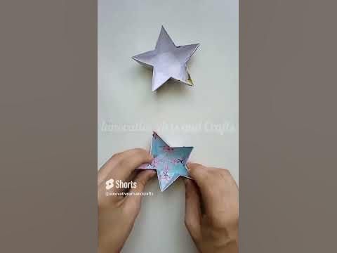 someone is cutting out some paper stars on the wall