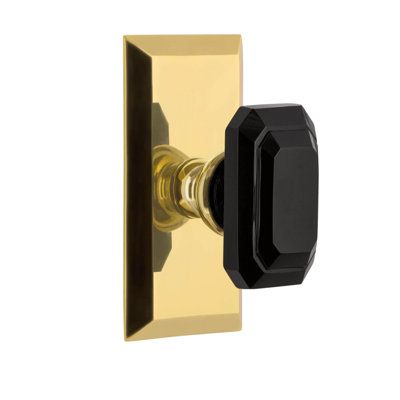 a black and gold door handle on a white background