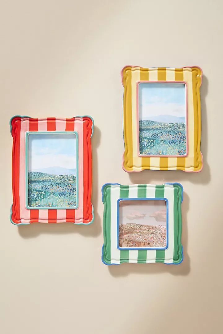 three colorful frames are hanging on the wall