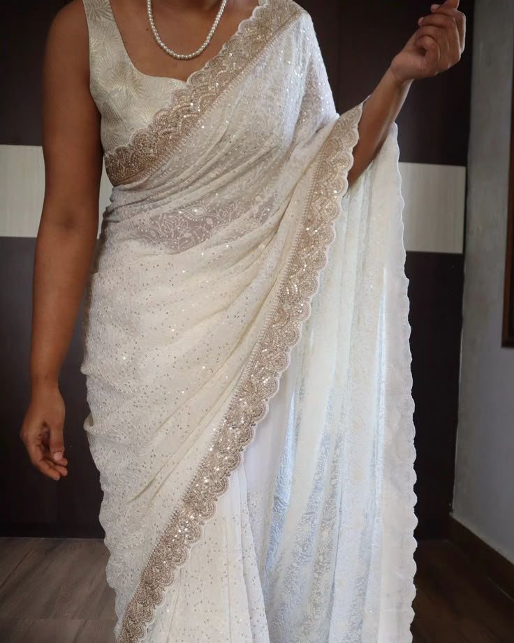 *An adorable chikankari collection with sabyasachi borders in scallop style on pure khaddi georgette silk saree* Pure fabric In elegant pearl white shade Pretty 😍 For ONLY FOR 8000💕💕 Pearl White Saree, Off White Saree Look, Sabyasachi Borders, White Saree Aesthetic, Nepali Clothing, White Saree Look, Saree Blouse Stitching, Indian Wedding Engagement, Lucknowi Chikankari Saree