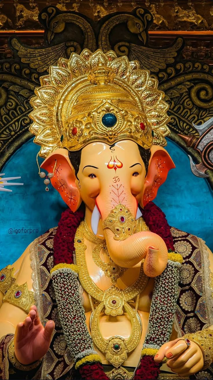 a statue of an elephant is shown in front of a blue and gold background,