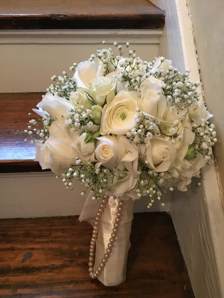 a bridal bouquet is sitting on the stairs