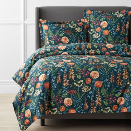 an image of a bed set with flowers on the comforter and pillowcases