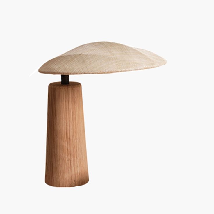 a wooden table lamp on a white background with the light turned off to show it's natural wood structure