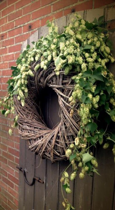 a wreath hanging on the side of a brick building