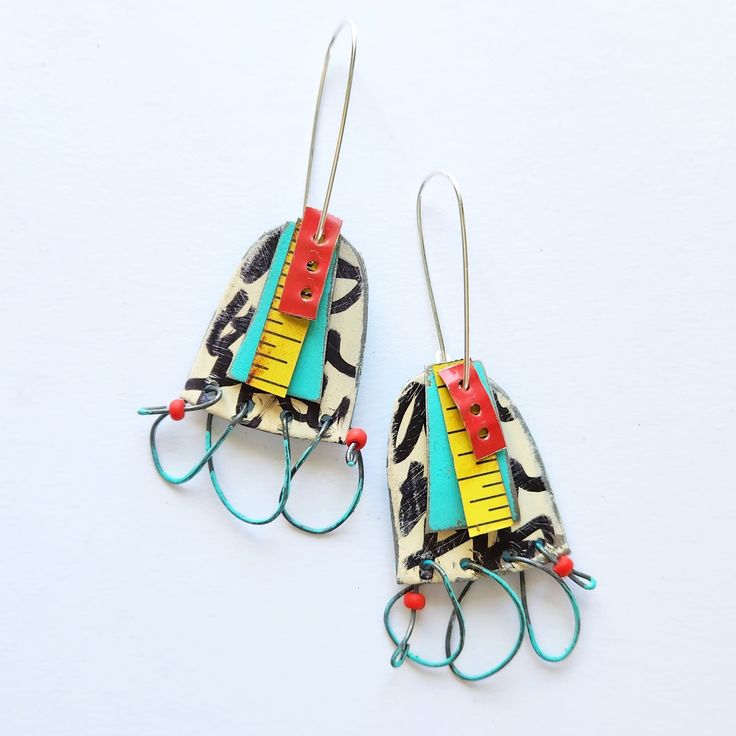 two pairs of earrings made out of paper and wire with colorful clips attached to them