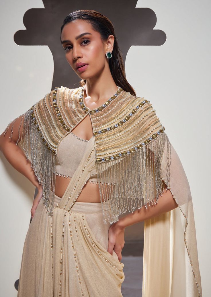 Embodying strength and style, our Tatiana sari set seamlessly combines effortless silhouettes, elegant drapery, delicate embroidery, and distinctive fringe details to create a look that is both soft and resilient. Elegant Draped Georgette Dupatta, Traditional Draped Embellished Blouse, Traditional Embellished Draped Blouse, Evening Draped Dupatta With Resham Embroidery, Designer Wear Dupatta With Tassels For Diwali, Embellished Blouse Piece For Reception With Traditional Drape, Traditional Drape Embellished Blouse Piece For Reception, Embellished Draped Traditional Wear For Reception, Traditional Drape Sets With Tassels For Eid