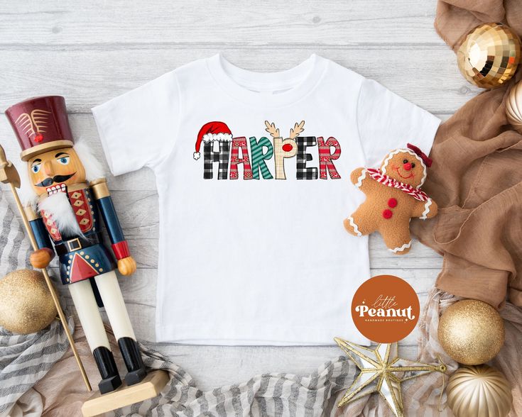 "This kids shirt has a Christmas name design that is printed directly onto the shirt using a commercial Direct to Garment printer. It can be personalized with your kids name. It is the perfect shirt to celebrate Christmas. Personalized Christmas Kids Shirt - Custom Name Christmas Toddler Shirt - Cute Santa Tee - Cute Reindeer Shirt ► SHIRT DETAILS: ☆ We use 100% cotton shirts and bodysuits ☆ Short and Long Sleeve Shirts ☆ Shirts and bodysuits run true to size ☆ Design is printed directly to the shirt using a commercial Direct to Garment printer that uses kid safe inks that are water-based and non-toxic. HOW TO ORDER: - Select your size from the drop down menu - For personalized items add your child's name to the \"Add your personalization\" field. - Add to cart - Select your shipping from Santa Tee, Snowman Shirt, Christmas Toddler, Reindeer Shirt, Christmas Shirts For Kids, Christmas Names, Cute Reindeer, Cute Santa, Name Christmas