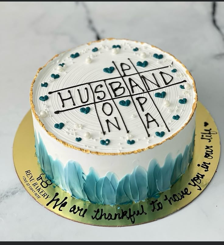 a cake that is sitting on top of a table with writing on the frosting