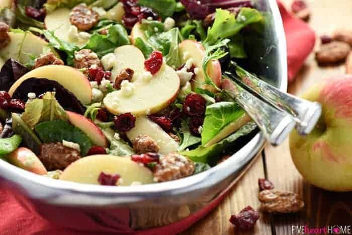 a salad with apples, cranberries and walnuts