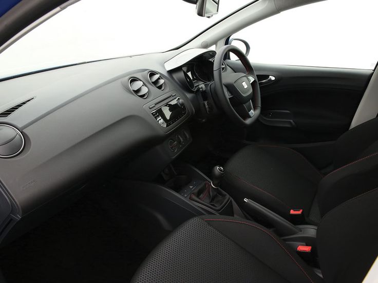 the interior of a small car with black seats