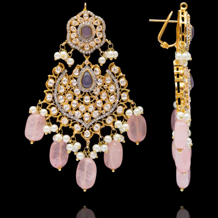 Indulge in the allure of this exquisite jewelry set and let contemporary grace redefine your fashion narrative! Radiate elegance and dangle in delight with our enchanting Esha Set – a mesmerizing blend of elegance and vibrancy meticulously crafted with sparkling zircons, complemented by the refreshing allure of lilac stones and dangling pink beads to elevate your style with the perfect harmony of sophistication and playfulness. The set includes a necklace, a maang teekah and a pair of trendy ear