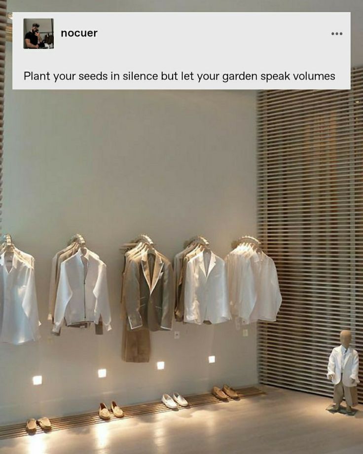 a room filled with lots of white shirts hanging on the wall next to each other