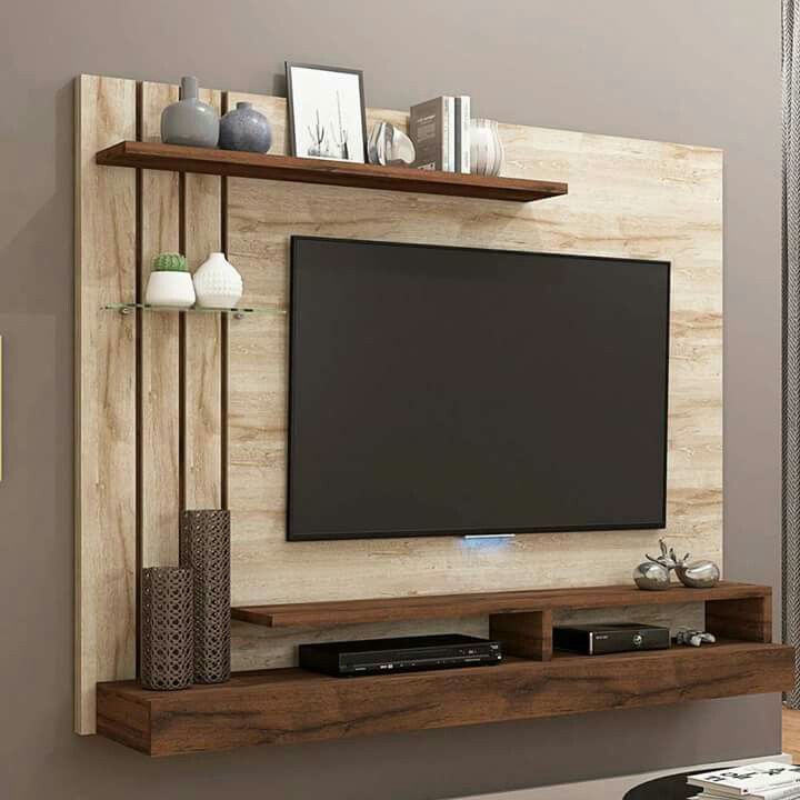 a flat screen tv mounted to the side of a wooden entertainment center in a living room