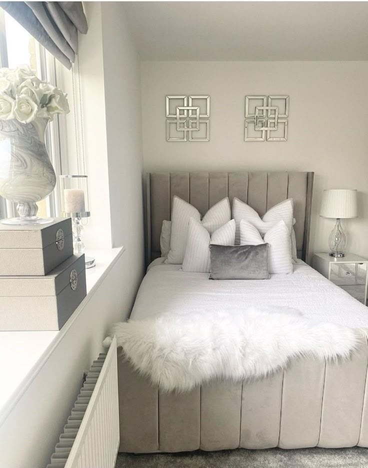 a bedroom with a bed, nightstands and pictures on the wall above it's headboard