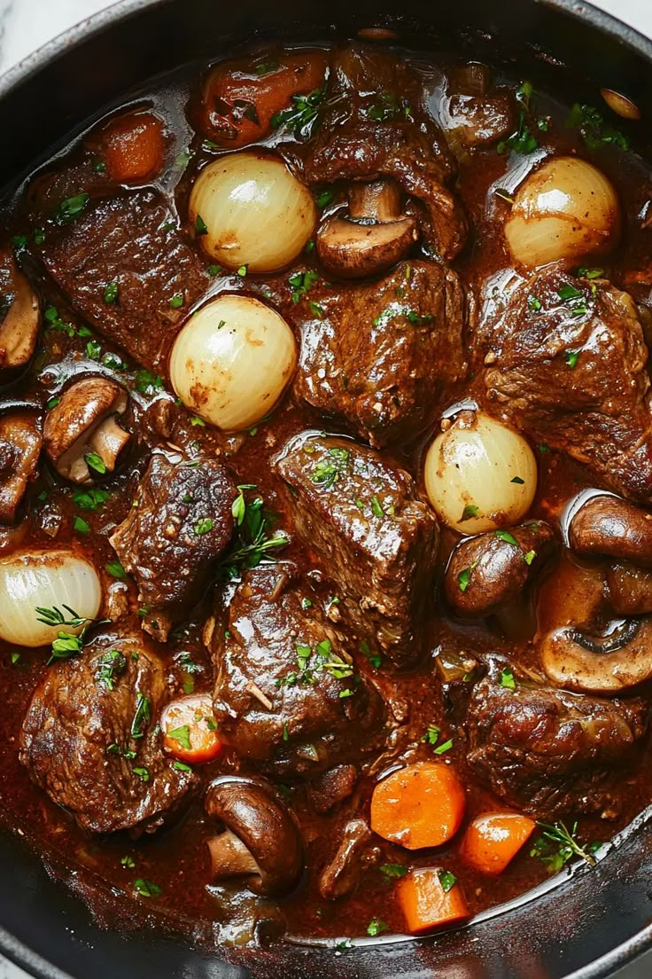 beef stew with mushrooms and carrots in a pot