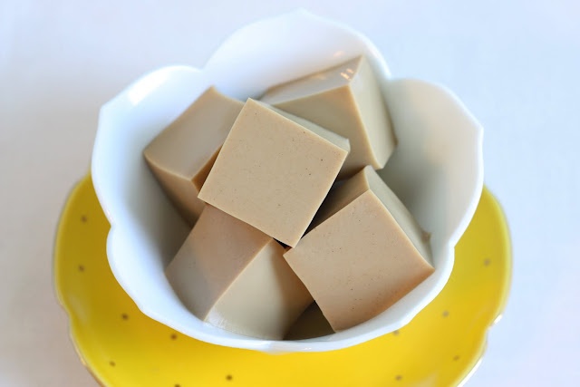 a yellow and white bowl filled with pieces of chocolate