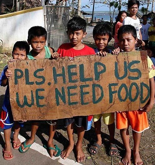 a group of children holding a sign that says pls help us we need food