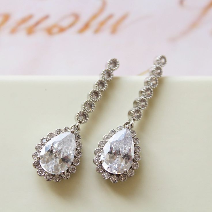 Tiny Vintage Style Bridal Earrings, Art Deco Earrings, Wedding Earrings Tiny  vintage style zircon  earrings  Colour: rhodium(silver tone) /clear Measurements: approx 3.6 cm x 1cm .  Materials:  rhodium components, zircon crystals . Stud earrings. Great for wedding or other celebration. MORE SAME STYLE: https://www.etsy.com/uk/shop/BridalArtDeco?ref=listing-shop-header-item-count&section_id=23918122 Please note some images have been enlarged to allow for details to be shown. Read the descriptions for details on actual size of each item.In all my shop listing I have made every effort to ensure that the images match the item as closely as possible! However, colours do vary on different monitors.  Thank you for visiting / shopping ! Elegant Drop Diamond Earrings For Wedding, White Chandelier Earrings With Prong Setting For Wedding, Wedding Diamond Dangle Earrings With Prong Setting, Wedding Diamond Earrings With Prong Setting, White Pear-shaped Diamond Earrings For Wedding, Wedding Halo Design Cubic Zirconia Earrings, Wedding Halo Earrings In Cubic Zirconia, Cubic Zirconia Halo Earrings For Wedding, Wedding Dangle Diamond Earrings With Prong Setting