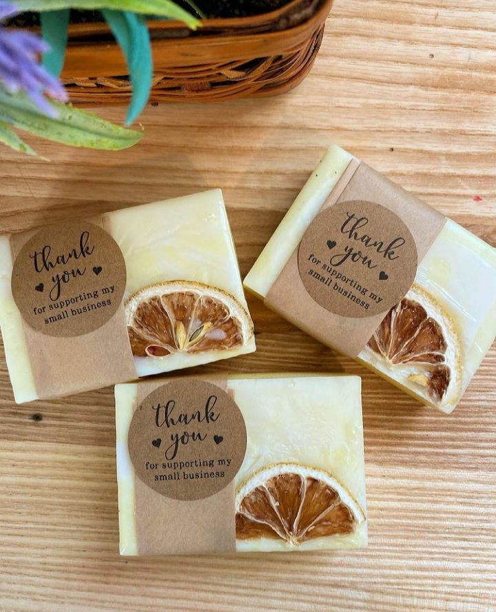 three soap bars with thank you written on them sitting next to a potted plant