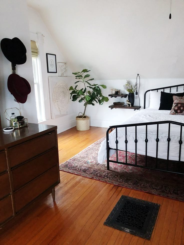 a bedroom with a bed, dresser and rug in it's centerpieces