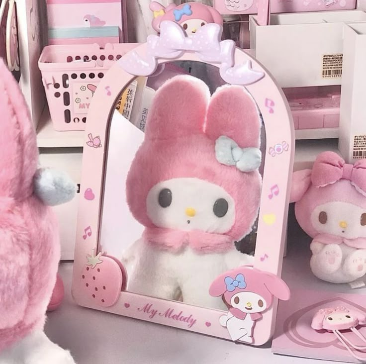 a hello kitty doll in front of a mirror with other stuffed animals around the room