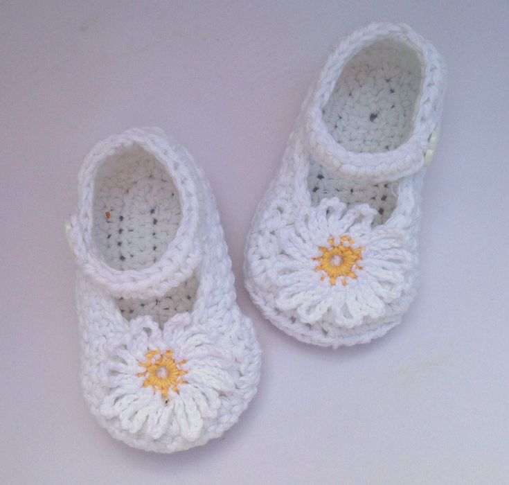 "These pretty crochet daisy shoes are perfect for spring and summer. They are made out of a lovely soft 100% cotton yarn,ideal for babies sensitive skin. The shoes are white with a white crochet daisy with yellow centre securely sewn onto the front of the shoe. A white button fastens the strap at the top of the shoe and helps to keep the shoe in place as well as give additional embellishment. The shoes are available in the following sizes newborn           3\" sole 0-3 months       3.25 \" sole Cute White Spring Booties, Cute White Summer Booties, Handmade White Closed Toe Booties, White Closed Toe Summer Booties, White Crochet Round Toe Booties, White Crochet Booties With Round Toe, Spring White Booties As Gift, Daisy Shoes, Crocheted Butterfly