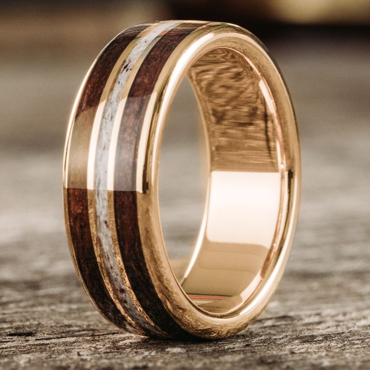 a wedding ring with two wood inlays