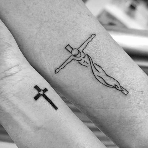 two people with tattoos on their arms, one has a cross and the other has a crucifix