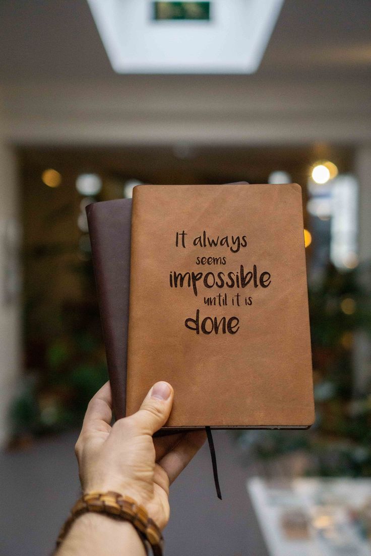 someone is holding up a book that says it always seems impossible and it's done