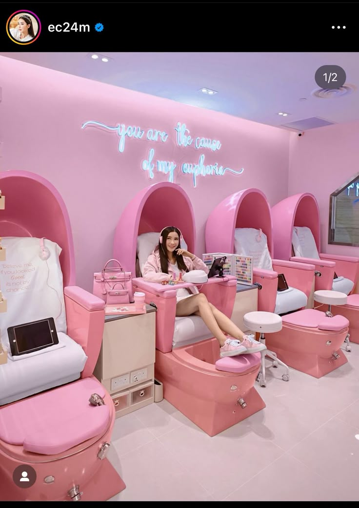 a woman is sitting in a pink room