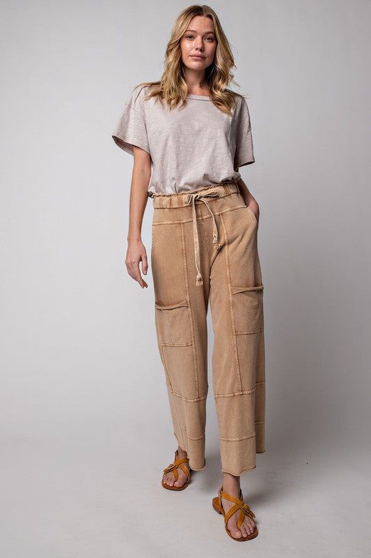 These must-have Terry Knit Wide Leg Pants are crafted from 100% cotton for maximum comfort and breathability. Featuring cargo style pockets, an elastic waistband and drawstring, and exposed seaming, they provide all-day comfort and style. Perfect for any occasion! Relaxed Fit Bottoms With Drawstring For Fall, Relaxed Bottoms With Drawstring For Fall, Relaxed Drawstring Bottoms For Fall, Spring Utility Sweatpants With Relaxed Fit, Spring Utility Style Relaxed Fit Sweatpants, Relaxed Cotton Parachute Pants For Loungewear, Everyday Sweatpants With Pockets, Relaxed Cotton Parachute Pants For Spring, Utility Parachute Pants For Loungewear