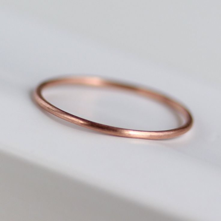 Skinny and minimal round midi ring, stacking ring, or wedding band. Made of 100% recycled materials. 0.8mm Round Ring 14k Rose Gold Size 2.75 Matte Finish Minimalist Stackable Promise Rings, Rose Gold Stackable Rings With Simple Design, Minimalist Rose Gold Stackable Rings Round Band, Classic Rose Gold Delicate Midi Rings, Simple Rose Gold Midi Rings, Minimalist 14k Rose Gold Stackable Rings As Gift, Simple Rose Gold Stackable Rings, Minimalist Rose Gold Midi Rings With Round Band, Minimalist Rose Gold Round Band Jewelry