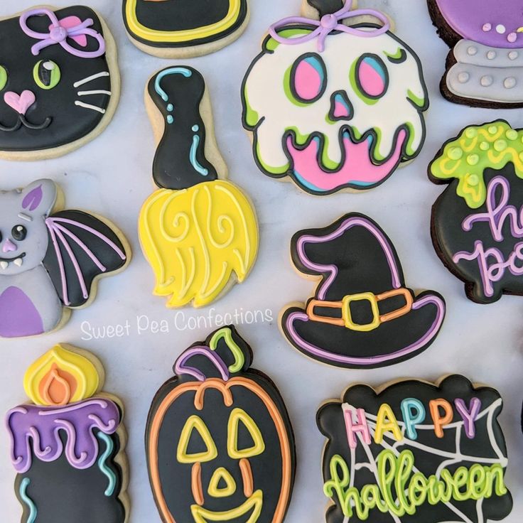 decorated halloween cookies are displayed on a table