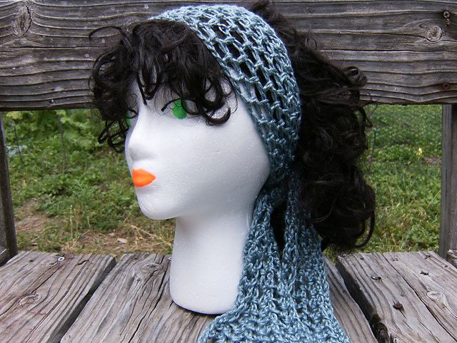 a mannequin head wearing a blue knitted hat