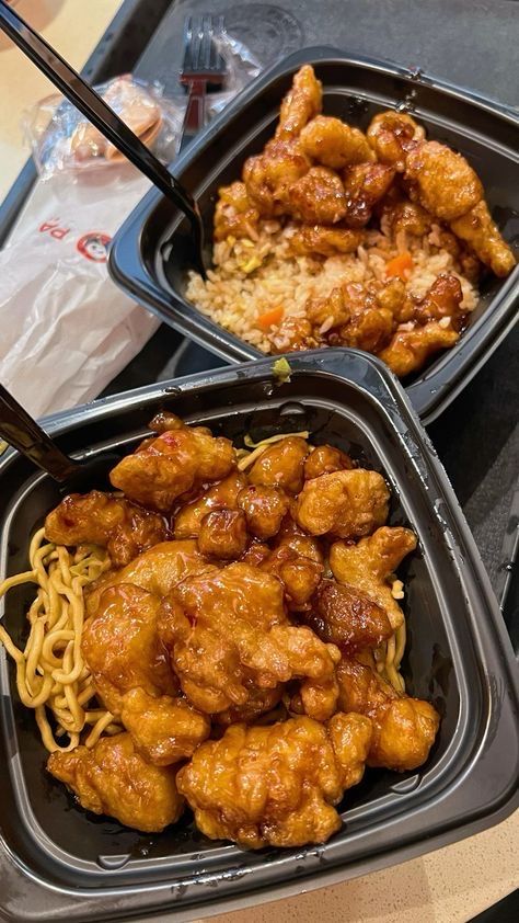 two plastic trays filled with food on top of a table