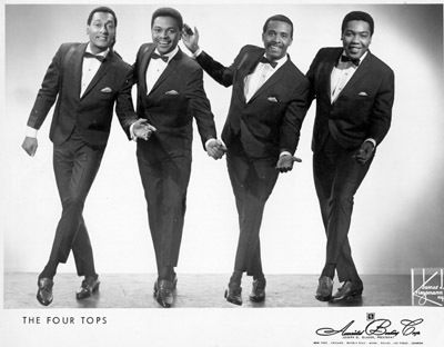 three men in tuxedos are posing for a photo