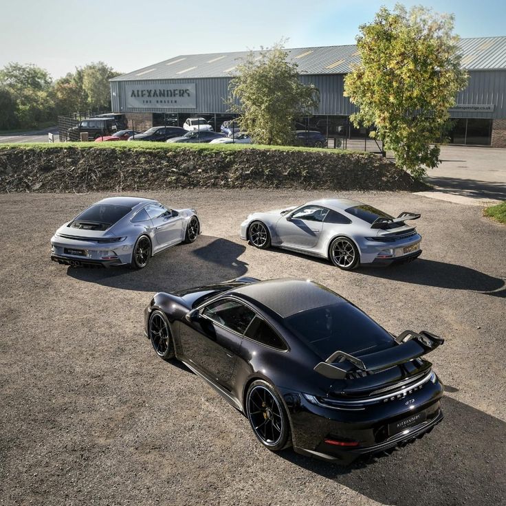 three black sports cars parked next to each other