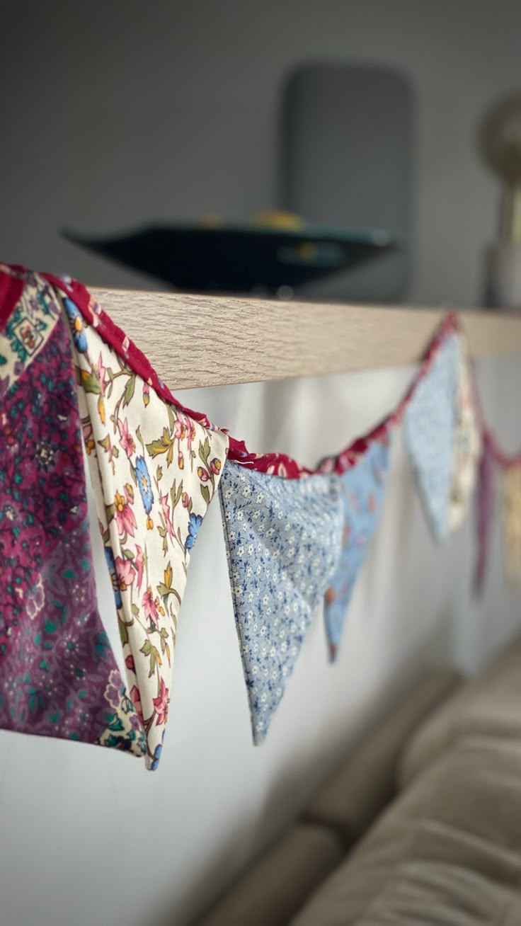 several colorful fabric buntings hanging from a wall